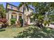 Charming home featuring a covered front porch, well-manicured lawn and colorful landscaping at 5503 Title Row Dr, Bradenton, FL 34210