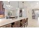 Open kitchen featuring a large island, breakfast bar seating and modern pendant lighting at 5503 Title Row Dr, Bradenton, FL 34210