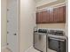 Modern laundry room featuring stainless steel washer and dryer at 5503 Title Row Dr, Bradenton, FL 34210