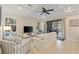 Bright living room with tile floors, coffered ceiling and sliding doors to the outdoor living area at 5503 Title Row Dr, Bradenton, FL 34210