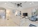 Comfortable living room with tile floors, coffered ceiling, and plenty of natural light at 5503 Title Row Dr, Bradenton, FL 34210