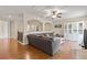 Open concept living room featuring hardwood floors, a comfortable sectional, and built-in shelving at 5503 Title Row Dr, Bradenton, FL 34210