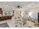 Open-concept living room with coffered ceiling, ceiling fan, bar seating and comfortable furniture at 5503 Title Row Dr, Bradenton, FL 34210