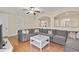 Cozy living room with a large sectional sofa, white coffee table, and stylish archways at 5503 Title Row Dr, Bradenton, FL 34210