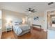 Bright main bedroom with hardwood floors, ceiling fan, and an ensuite bathroom at 5503 Title Row Dr, Bradenton, FL 34210