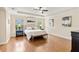 The primary bedroom features tray ceilings, windows, and hardwood flooring at 5503 Title Row Dr, Bradenton, FL 34210