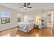 Inviting main bedroom featuring hardwood floors, neutral colors, a ceiling fan, and natural light from the window at 5503 Title Row Dr, Bradenton, FL 34210