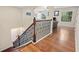 A staircase with elegant wood and iron railing ascends from the foyer to the upper level, showcasing a bright and open design at 5503 Title Row Dr, Bradenton, FL 34210
