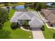Aerial view of a well-maintained home with manicured landscaping and a pristine roof at 5782 Sandy Pointe Dr, Sarasota, FL 34233