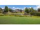 Expansive backyard with a tranquil pond view, lush greenery, and well-maintained lawn at 5782 Sandy Pointe Dr, Sarasota, FL 34233