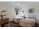 Shared bedroom with two beds, a ceiling fan, and a view of the neighborhood through the window at 5782 Sandy Pointe Dr, Sarasota, FL 34233