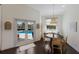 Breakfast nook with access to the pool and a woven pendant light fixture above the wood table at 5782 Sandy Pointe Dr, Sarasota, FL 34233