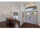 Entryway with statement lighting, and adjacent dining room at 5782 Sandy Pointe Dr, Sarasota, FL 34233