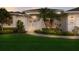 Charming home with a well-manicured lawn, front garden beds, and a covered front entryway at 5782 Sandy Pointe Dr, Sarasota, FL 34233