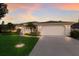 Charming single-story home with a manicured lawn and a side entry two-car garage at 5782 Sandy Pointe Dr, Sarasota, FL 34233