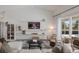 Living room featuring a fireplace and sliding glass doors to the backyard at 5782 Sandy Pointe Dr, Sarasota, FL 34233
