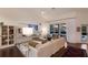 Bright and airy living room with vaulted ceilings, an oversized couch, and views of the backyard pool at 5782 Sandy Pointe Dr, Sarasota, FL 34233
