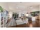 Sun-soaked open floor plan with vaulted ceilings, a large sectional, and a view of the outdoor pool at 5782 Sandy Pointe Dr, Sarasota, FL 34233