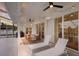Relaxing patio with lounge chairs, seating, ceiling fans, and string lights at 5782 Sandy Pointe Dr, Sarasota, FL 34233