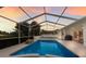 Screened-in pool with attached hot tub and string lights at 5782 Sandy Pointe Dr, Sarasota, FL 34233