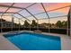 View of a refreshing screened-in pool with an attached spa at 5782 Sandy Pointe Dr, Sarasota, FL 34233
