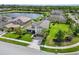 Beautiful home with manicured lawn, landscaping, and a serene lake view at 5978 Anise Dr, Sarasota, FL 34238