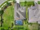 Aerial perspective of an upscale home boasting a screened-in pool, landscaped yard, and meticulously maintained lawn at 5978 Anise Dr, Sarasota, FL 34238