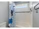 Bright bathroom featuring a white tiled shower/tub combo with a decorative accent tile and modern fixtures at 5978 Anise Dr, Sarasota, FL 34238