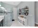 Bathroom boasting a glass shower, vanity, and decorative wall shelves at 5978 Anise Dr, Sarasota, FL 34238