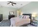 Comfortable bedroom with light green walls, with a dark wooden dresser and neutral accents at 5978 Anise Dr, Sarasota, FL 34238