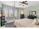Relaxing bedroom with soft green walls, neutral decor, and ample natural light from multiple windows at 5978 Anise Dr, Sarasota, FL 34238