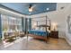 Bright and airy bedroom with a four-poster bed, large windows, and a view of the backyard at 5978 Anise Dr, Sarasota, FL 34238