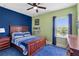 Colorful bedroom with unique decor, featuring a wooden bed frame and vibrant wall colors at 5978 Anise Dr, Sarasota, FL 34238