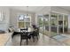 Cozy dining area with a round table, window views, and access to the outdoor pool area through sliding glass doors at 5978 Anise Dr, Sarasota, FL 34238