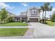 Beautiful two-story home showcasing a lush, green lawn, well-manicured landscaping and a spacious driveway at 5978 Anise Dr, Sarasota, FL 34238