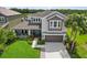 Charming two-story home with a well-manicured lawn, lush landscaping, and an attached two-car garage at 5978 Anise Dr, Sarasota, FL 34238