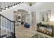 Elegant foyer showcasing a grand staircase, arched doorways, and stylish furnishings, creating a luxurious entrance at 5978 Anise Dr, Sarasota, FL 34238
