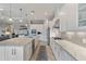 Spacious kitchen with white cabinetry, stainless steel appliances, and granite countertops, showcasing modern design at 5978 Anise Dr, Sarasota, FL 34238