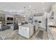 Open kitchen to living area showcases modern design with a large island, and high-end appliances at 5978 Anise Dr, Sarasota, FL 34238