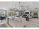 Open-concept kitchen featuring island with breakfast bar, stainless appliances and seamless flow to living area at 5978 Anise Dr, Sarasota, FL 34238