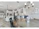 Open kitchen and dining area featuring modern lighting fixtures, white cabinetry, and seamless flow for entertaining at 5978 Anise Dr, Sarasota, FL 34238