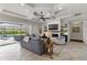 Bright living room showcasing a modern fireplace, built-in shelving, and a seamless flow to the outdoor pool area at 5978 Anise Dr, Sarasota, FL 34238
