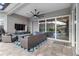 Covered patio offers a comfortable seating area, ceiling fan, and access to the pool, great for relaxation and entertaining at 5978 Anise Dr, Sarasota, FL 34238