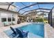 Enjoy the luxurious screened-in pool area with a hot tub and comfortable seating at 5978 Anise Dr, Sarasota, FL 34238