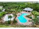 Aerial view of community pool and splash park with ample seating, mature landscaping and lots of space at 5978 Anise Dr, Sarasota, FL 34238