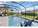 Beautiful pool with a screened-in enclosure, featuring a hot tub and relaxing lounge chairs at 5978 Anise Dr, Sarasota, FL 34238
