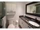The bathroom features granite counters, white cabinets and a glass shower at 625 30Th W Ave # G210, Bradenton, FL 34205