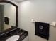 Bathroom showing marble counter and dark mirror in a well lit space at 625 30Th W Ave # G210, Bradenton, FL 34205