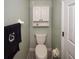 Well lit bathroom features a toilet, cabinet and towel hanging on wall at 625 30Th W Ave # G210, Bradenton, FL 34205