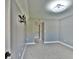 This bedroom has neutral paint and carpet along with a large light fixture and access to a hallway at 625 30Th W Ave # G210, Bradenton, FL 34205